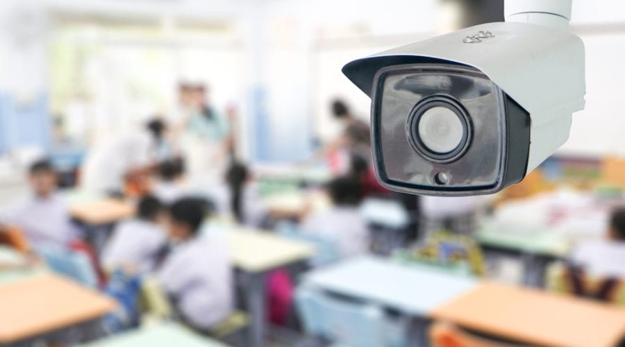 Security system monitoring students in classroom at school