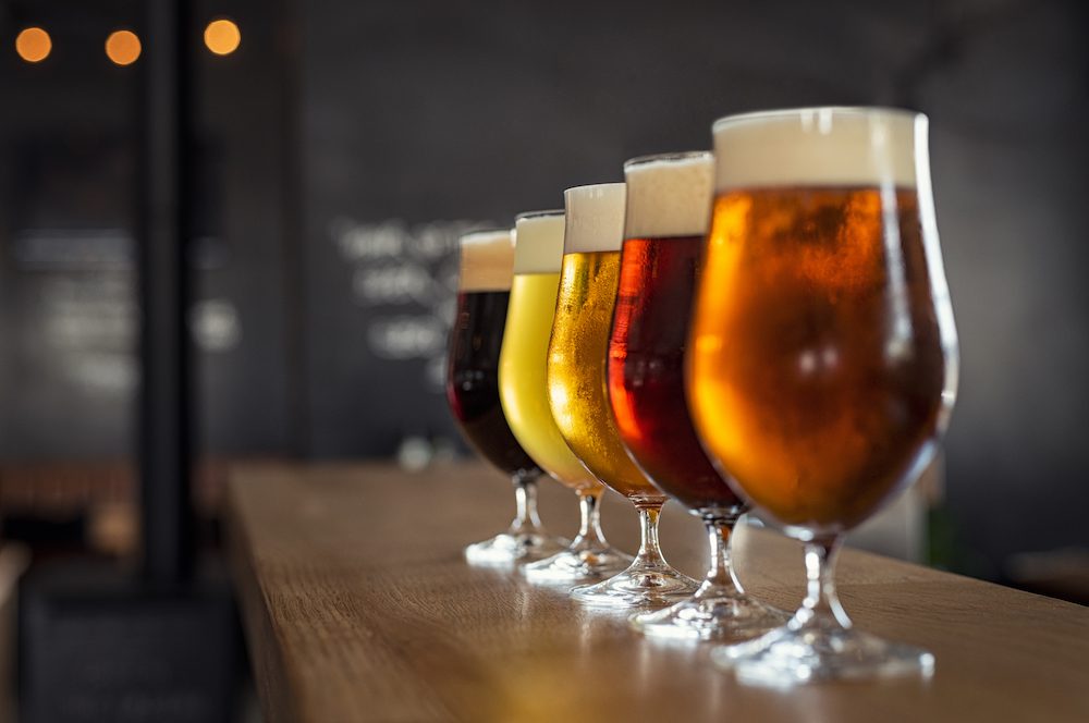 glasses of craft beer on wooden bar